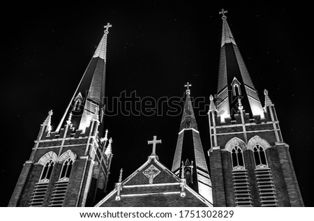 Black and white photograph of Holy Family Cathedral located in downtown Tulsa, Oklahoma. Photo was taken at night. 