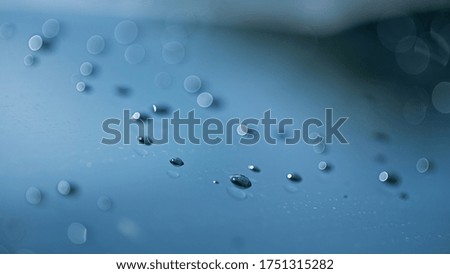 Macro dew water on car window with bokeh background 