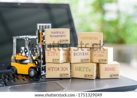 Online portfolio management for long-term sustainable growth, asset allocation and investment concept : Boxes of financial products e.g bonds, commodities, stocks, mutual fund, ETFs, REITs on a laptop Royalty-Free Stock Photo #1751329049