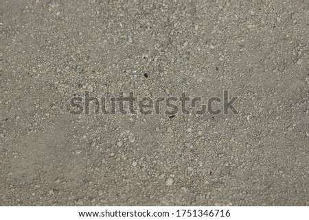 Gray gravel covering a dusty road in the countryside. Off road, long real modern travel