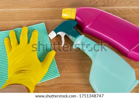 Picture of colorful cleaning supplies and tools on wooden background