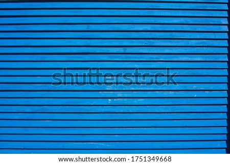 Blue wall of thin horizontal boards background or texture