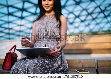Cropped view of female illustrator creating graphic content during freelance work on modern touch pad,millennial woman with electronic stylus using digital tablet for making online booking and banking