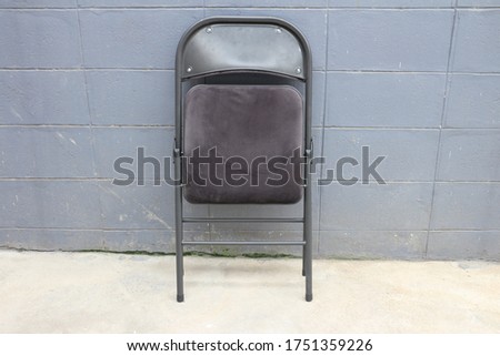 The chair is folded up. Photographed from the front. Royalty-Free Stock Photo #1751359226