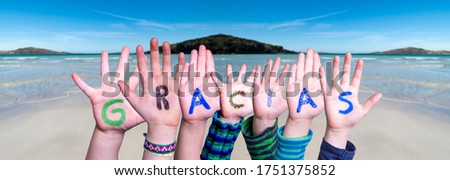 Many Children Hands Building Word Gracias Means Thank You, Ocean Background