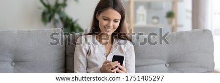 Horizontal photo banner for website header design young pretty woman holding cell sit on couch spend free time using virtual communication chat with friends, buy in e-shop websites enjoy internet fun