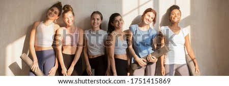 Six diverse girls wear active wear resting after work out holding mats looking at camera. Sport club trainers, happy sportive women portrait concept. Horizontal photo banner for website header design