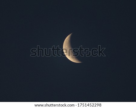 crescent moon floating in the dark night sky