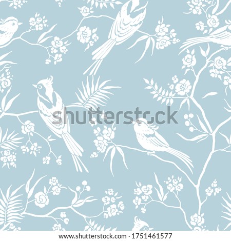 Seamless pattern in oriental style with blooming branches trees and birds. Wildlife silhouette, white floral ornament on blue background. Vector hand drawn illustration, garden in japanese style.