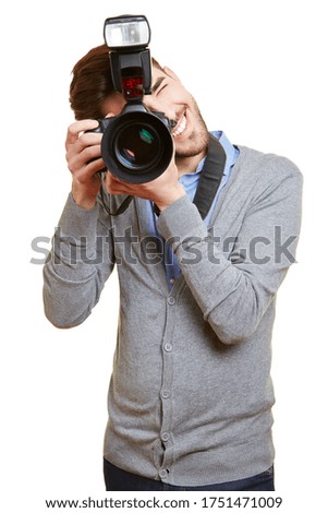 Young man photographs with a large digital camera