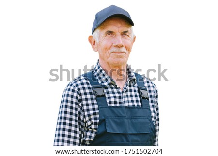 Senior professional worker in overall and cap. Aged farmer. Old craftsman. Isolated on white background   Royalty-Free Stock Photo #1751502704