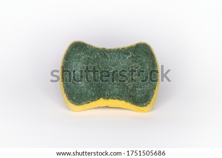 Old sponges for washing dishes and have signs of use. The sponge has two layers. Consists of the top layer are green and the bottom layer is the yellow and white background
