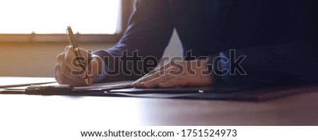 Male lawyer working at table in office, closeup. Banner design