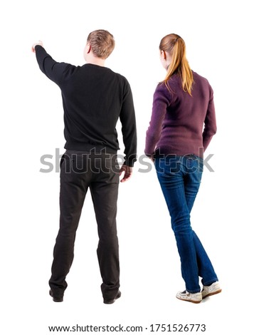 Back view of couple in sweater pointing. Rear view people collection. backside view of person. Isolated over white background.