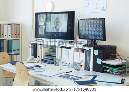 Background image of modern computer equipment for telemedicine and online consultation in clinic, focus on digital screens with CT scans, copy space