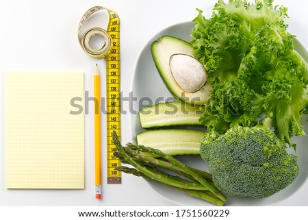 Bunch of vegetables isolated on white background. salad tape weight. Pile of fresh vegetables with measuring tape. Green vegetable smoothie.