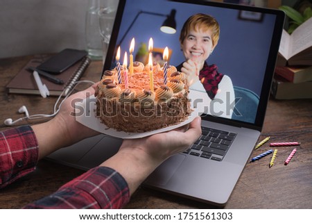Asian middle aged woman feeling loved and happy while celebrating virtual birthday via video call at home during social distancing