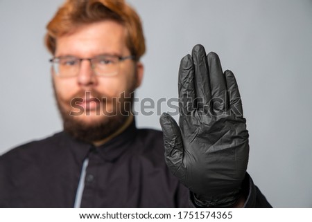 male portrait doctor hand stop sign global health care crisis corona virus pandemic concept studio photography on neutral gray gradient background space for copy or text