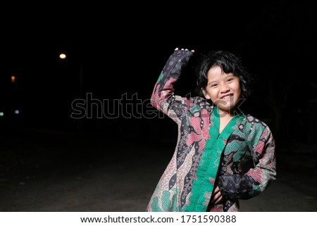 Malay girl celebrating Hari Raya Aidilfitri , posing at night