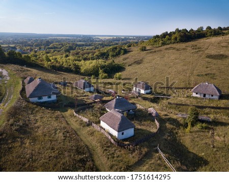 Aerial view of beautiful Slavic village in spring countryside.