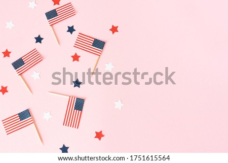 Many american flags and stars on pink background, flat lay. Celebration in America. 4th of july, happy usa independence day. Copy space for text.