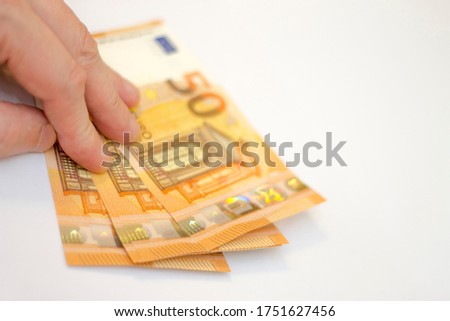 Man hold a Stack of Fifty euro banknotes laying isolated on white background