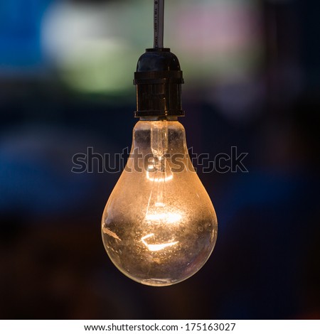 old light bulb glowing in dark Royalty-Free Stock Photo #175163027