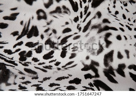 Black and white abstract camouflage. The concealment pattern on a fabric. Concept of winter masking.