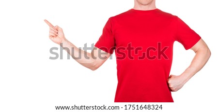 Man in red t-shirt pointing arm and fingers on the side isolated white background with clipping path. Concept of t shirt template or delivery