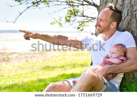 A Beautiful father And Baby outdoors. Dad and her Child playing together