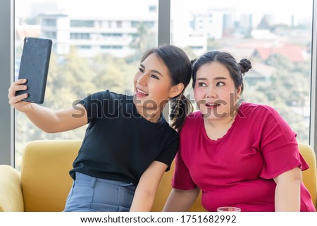 Stay at home; Couple of smiling teenagers in sunglasses taking selfie with tablet