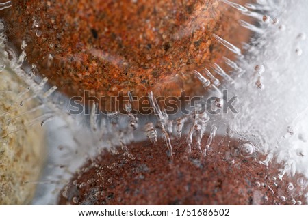 Abstract River Pebbles Frozen in Clear Water