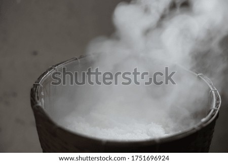 Blurred picture of white smoke from steaming glutinous rice in countryside kitchen