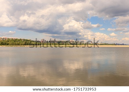 The landscape is a view of the lake with a clear blue sky and thick clouds. reflections in the water. It's a beautiful summer day. . High quality photo