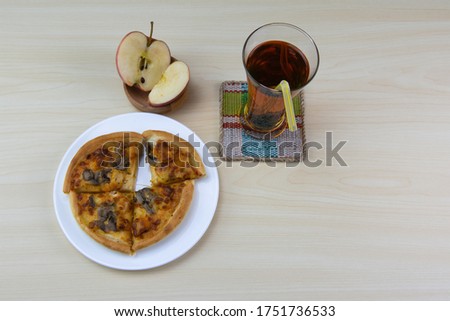 Homemade mini pizza and apple juice for healthy dinner.
