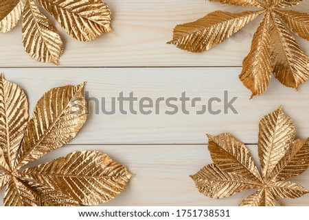 Gold leaf design elements around the edge of the frame. Frame of golden leaves of chestnut.