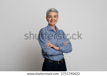 Female Entrepreneurship. Portrait Of Confident Middle-Aged Woman Posing With Folded Arms Over Light Studio Background, Copy Space