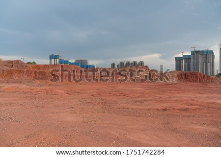 Sand and gravel vacant lot and building under construction