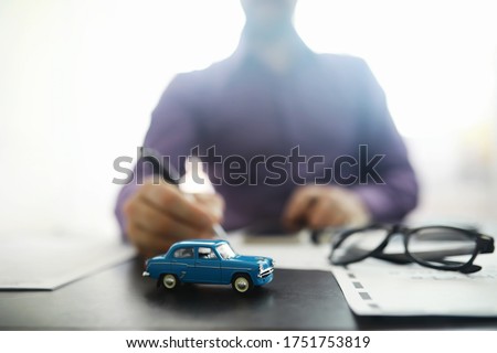 The insurance agent signs a document. Car insurance policy. Auto insurance policy. Forms registration of the contract. Royalty-Free Stock Photo #1751753819