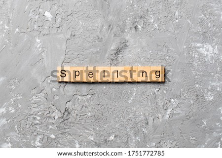 spelling word written on wood block. spelling text on cement table for your desing, concept.