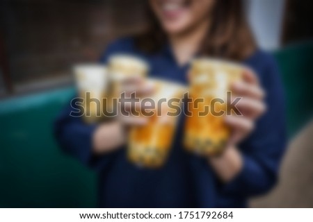 Homemade Milk Bubble Tea with Tapioca Pearls on blurry background