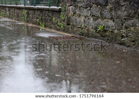 Raining on a Street with Manhole