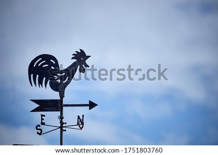 a weather vane in the sky Royalty-Free Stock Photo #1751803760