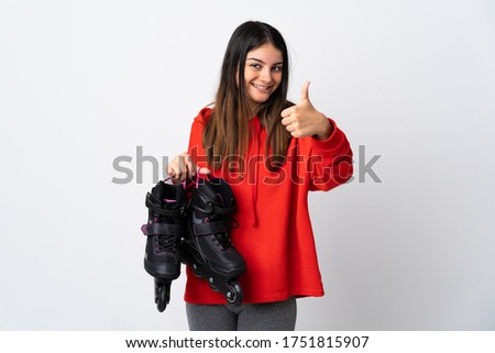 Young skater woman isolated on white background with thumbs up because something good has happened