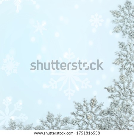 Silver Christmas snowflake frame on light blue background.  Christmas, elegant 2021 New Year trendy greeting card, frame. Winter holidays concept. Mock up, banner