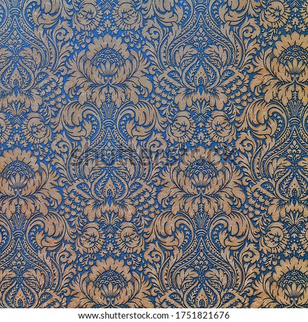 Blue ceramic tile with abstract floral pattern for wall and floor decoration. Concrete stone surface background. Vintage texture with ornament  for interior design project.