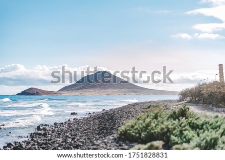 Panoramic view at the volcanic beach in the bohemian village of El Medano, Tenerife, Canary Islands, Spain. Travel photography concept.