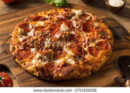 Savory Homemade Meat Lovers Pizza with Pepperoni and Bacon Royalty-Free Stock Photo #1751836328