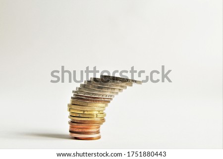 Stack money coins are about to fall down.photo isolate on white copy space 