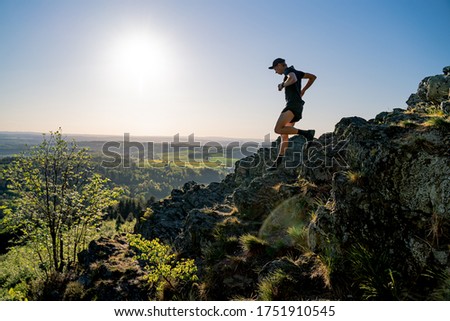 Trail Runner runs down the rocky mountains